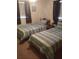 Two twin beds in a well-lit bedroom with striped bedding at 4031 Cluster Dr, Holiday, FL 34691