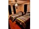 Two twin beds in a bright bedroom with striped bedding and ceiling fan at 4031 Cluster Dr, Holiday, FL 34691