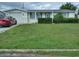 Ranch-style home with a spacious yard and a single-car garage at 4031 Cluster Dr, Holiday, FL 34691