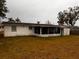 Exterior view of house, showing back and screened porch at 4031 Cluster Dr, Holiday, FL 34691
