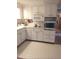 Kitchen features white cabinets and a built-in oven at 4031 Cluster Dr, Holiday, FL 34691