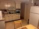 Kitchen with white cabinets, built-in appliances, and tiled floor at 4031 Cluster Dr, Holiday, FL 34691