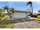 Attached garage with a white door and landscaping at 4188 104Th N Ave, Clearwater, FL 33762