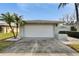 Attached two-car garage with a white door at 4188 104Th N Ave, Clearwater, FL 33762