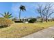 Single-story house with a large yard and palm trees at 4188 104Th N Ave, Clearwater, FL 33762
