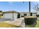 Single-story home with a two-car garage and landscaped yard at 4188 104Th N Ave, Clearwater, FL 33762