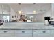 Modern kitchen with granite countertops and white cabinets, open to the living room at 4188 104Th N Ave, Clearwater, FL 33762