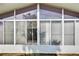 Exterior view of sunroom with large windows and white frame at 4188 104Th N Ave, Clearwater, FL 33762