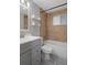 Updated bathroom with gray vanity, shower, and tile flooring at 4925 Beacon Hill Dr, New Port Richey, FL 34652