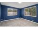 Spacious bedroom with blue walls and tile flooring at 4925 Beacon Hill Dr, New Port Richey, FL 34652