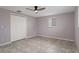 Bedroom with tile floors, ceiling fan, and double door closet at 4925 Beacon Hill Dr, New Port Richey, FL 34652
