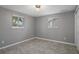 Well lit bedroom with tile floors and two windows at 4925 Beacon Hill Dr, New Port Richey, FL 34652