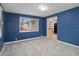 Bright bedroom with blue walls and tile floors at 4925 Beacon Hill Dr, New Port Richey, FL 34652