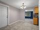 Tiled dining room with a chandelier and view to kitchen at 4925 Beacon Hill Dr, New Port Richey, FL 34652