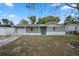 Gray house with white trim, attached garage, and a landscaped yard at 4925 Beacon Hill Dr, New Port Richey, FL 34652