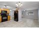 Eat-in kitchen, featuring wood cabinets and black appliances at 4925 Beacon Hill Dr, New Port Richey, FL 34652