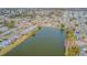 Aerial view of neighborhood with lake at 5040 Victoria Ln, Holiday, FL 34690
