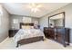 Bedroom with dresser, queen bed, and ceiling fan at 5040 Victoria Ln, Holiday, FL 34690