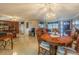 Dining room with wood table and chairs, and view into kitchen at 5040 Victoria Ln, Holiday, FL 34690