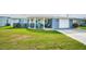 Cute ranch home with circular driveway, carport, and landscaped lawn at 5040 Victoria Ln, Holiday, FL 34690