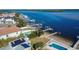 Aerial view of waterfront home, pool, and private dock at 6323 Bayou Grande Ne Blvd, St Petersburg, FL 33702
