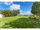 Landscaped backyard with lush lawn and waterfront access at 6323 Bayou Grande Ne Blvd, St Petersburg, FL 33702