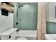 Updated bathroom with a teal glass tile shower and new fixtures at 6323 Bayou Grande Ne Blvd, St Petersburg, FL 33702