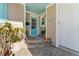 Quaint front entrance with teal door and stone steps at 6323 Bayou Grande Ne Blvd, St Petersburg, FL 33702