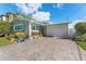 One-story home with a large paved driveway and landscaped lawn at 6323 Bayou Grande Ne Blvd, St Petersburg, FL 33702