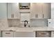 White shaker cabinets, farmhouse sink, and quartz countertops at 6323 Bayou Grande Ne Blvd, St Petersburg, FL 33702