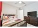 Bedroom with a queen bed, dresser, and TV at 6684 Devlin Ln, Wesley Chapel, FL 33545