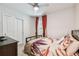 Cozy bedroom with double doors and red curtains at 6684 Devlin Ln, Wesley Chapel, FL 33545