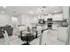 Bright dining area with glass table and four white chairs at 6684 Devlin Ln, Wesley Chapel, FL 33545