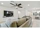 Living room with sectional sofa and large flat-screen TV at 6684 Devlin Ln, Wesley Chapel, FL 33545