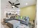 Spacious living room featuring a sectional sofa and ceiling fan at 6684 Devlin Ln, Wesley Chapel, FL 33545