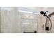 Modern shower with glass enclosure, dual shower heads, and stylish wall tile at 6684 Devlin Ln, Wesley Chapel, FL 33545