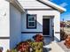 Front entry with dark brown door and well-maintained landscaping at 682 Olive Conch St, Ruskin, FL 33570