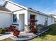 Front entry with dark brown door and well-maintained landscaping at 682 Olive Conch St, Ruskin, FL 33570