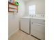 Bright laundry room with washer and dryer, and overhead storage at 682 Olive Conch St, Ruskin, FL 33570