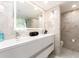 Elegant bathroom featuring a double vanity and marble tile at 855 Bayway Blvd # 804, Clearwater Beach, FL 33767