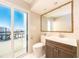 Clean bathroom with vanity, toilet and shower, plus balcony view at 855 Bayway Blvd # 804, Clearwater Beach, FL 33767