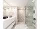 Modern bathroom with marble floors, walk-in shower, and double vanity at 855 Bayway Blvd # 804, Clearwater Beach, FL 33767