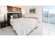 Bright bedroom with a comfortable bed and balcony access at 855 Bayway Blvd # 804, Clearwater Beach, FL 33767