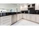 Well-equipped kitchen with stainless steel appliances and black countertops at 855 Bayway Blvd # 804, Clearwater Beach, FL 33767