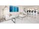 Modern living room features white leather sectional sofa, marble floors, and breakfast bar at 855 Bayway Blvd # 804, Clearwater Beach, FL 33767