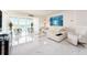 Bright living room with white leather furniture and waterfront views at 855 Bayway Blvd # 804, Clearwater Beach, FL 33767