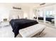 Elegant main bedroom with mirrored closet and white leather bench at 855 Bayway Blvd # 804, Clearwater Beach, FL 33767