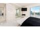Luxurious bedroom with marble floors, walk-in shower, and city views at 855 Bayway Blvd # 804, Clearwater Beach, FL 33767