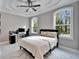 Bedroom with a comfortable bed, large windows, and a workspace at 9401 93Rd St, Seminole, FL 33777