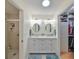 Elegant bathroom with double vanity, walk-in shower, and large closet at 1006 Mcdaniel St # 21, Sun City Center, FL 33573